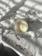 Lavender Nights beeswax candle infused with lavender essential oils. Dried lavender in the back 