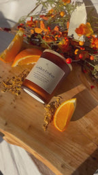 Golden Ember beeswax candle with amber essential oils, warm cozy glow.